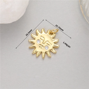 Detail of 14K gold sun pendant with facial features and dimensions 20.2mm by 16.75mm