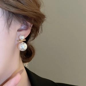 Minimalist double faux pearl earrings with gold bar studs shown on model ear