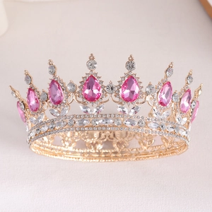 Detail of golden bridal crown with pink teardrop crystals and sparkling rhinestones