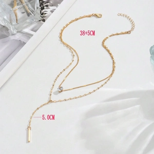 Double-layered Y-shaped gold necklace with crystal zircon droplet and vertical metal bar pendant