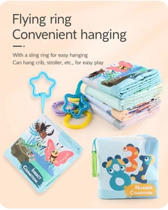 Detailed close-up of soft washable baby cloth books with insect and number learning patterns