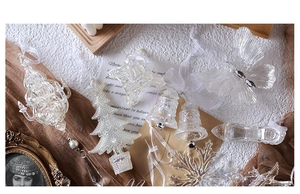 Transparent acrylic Christmas ornaments including butterfly and snowflake on brown tulle