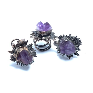 Detailed view of vintage starburst amethyst rings with a unique spiral metal band