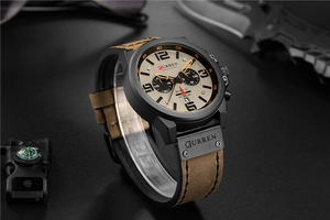 Detail showing multifunctional chronograph watch with brown leather strap and black casing