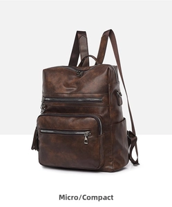 Detail view of the vintage brown faux leather backpack with multiple zip pockets