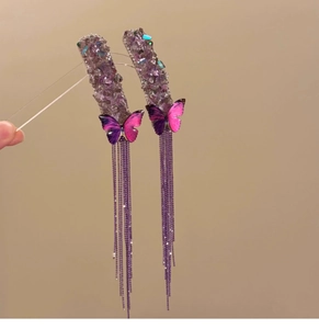 Macro shot of purple butterfly tassel earrings featuring gradient crystals and fine metal fringe