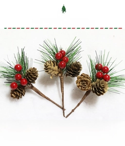 Close-up of artificial pine needles with natural pine cones and red berries for Christmas
