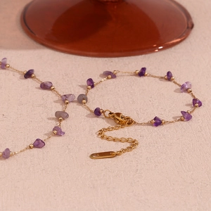 Detailed close-up of amethyst stone beads and 18K gold-plated adjustable chain link