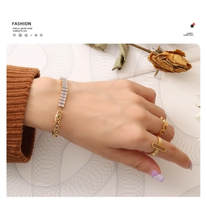 Close-up of gold geometric bracelet set with square zircons on model's wrist