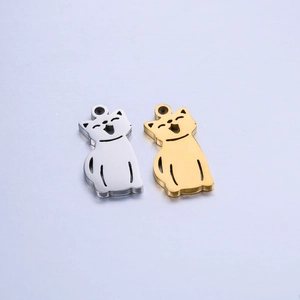 Detailed view of cat-shaped stainless steel charms with cutout details in gold and silver
