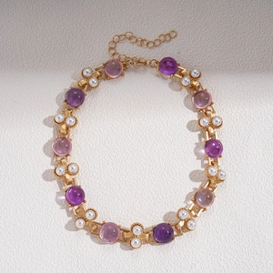Detail of vintage gold necklace with purple resin gems, faux pearls and adjustable clasp