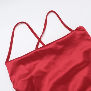 Close-up of red silk satin evening dress showing thin straps and premium fabric texture