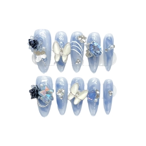 Ice blue long pointed press-on nails with white 3D butterflies and sparkling rhinestones