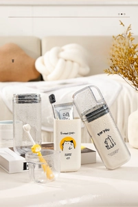 Close-up of portable travel wash cup featuring cute illustrations and hanging strap