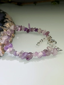 Macro shot of irregular purple amethyst crystal bracelet with adjustable silver lobster clasp