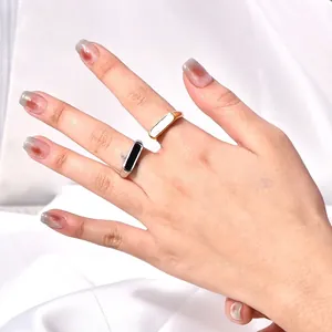 Minimalist geometric titanium steel rings with mother of pearl inlay on white silk fabric