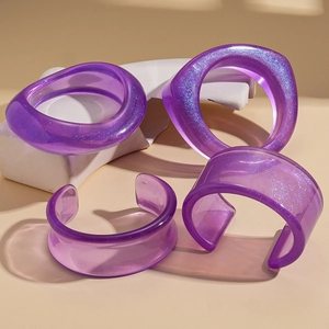 Irregular purple resin bangle set with glitter sparkles and a translucent modern design