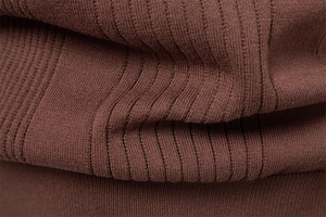 Macro shot of dark brown ribbed knit fabric showing fine texture and soft material quality
