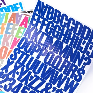 Close-up of waterproof dark blue vinyl letter stickers showing clear water droplets on surface