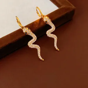 Elegant gold plated snake hoop earrings with pavé zircons and black gemstone eyes