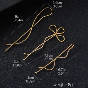 Detailed view of three gold alloy hair clips with dimensions in centimeters and inches