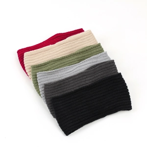 Detail showing various colors of ribbed knit headbands in a neat stacked arrangement