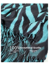 Close-up of zebra pattern knitted scarf featuring teal and black stripes with fringe trim