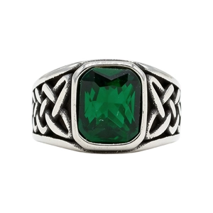 Vintage steel ring with emerald green gemstone and Celtic knot patterns on white background
