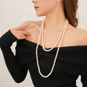 Close-up of elegant double-layered white pearl necklace worn by a female model