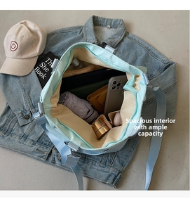 Interior view of mint green canvas tote bag showing spacious storage for daily items
