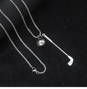 Macro detail of silver golf club and ball pendant on a box chain with black background