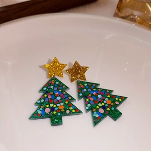 Macro shot of green Christmas tree earrings with colorful sequins and golden star details