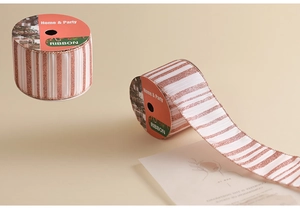 Detail of rose gold and white striped glitter ribbon for elegant Christmas DIY gift wrapping