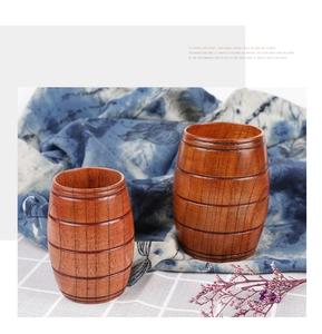 Detailed close-up of natural wooden barrel mugs with unique grain texture and handle