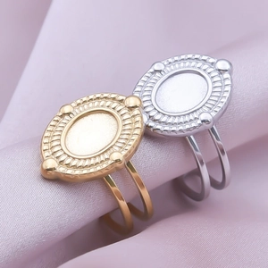 Detailed close-up of retro oval rings with radial texture on pink silk fabric
