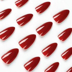 Glossy deep red stiletto press-on nails set in medium-long length on white background