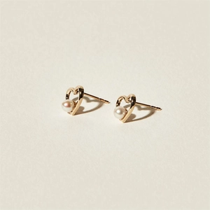 Elegant gold heart earrings with white pearls, minimalist 925 silver studs shown at an angle