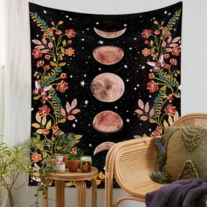 Bohemian black moon phase tapestry with flowers and butterflies in a cozy room setting