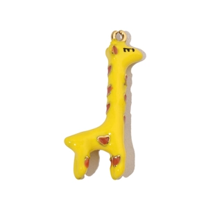 Detail of yellow giraffe pendant with heart spots and gold metal edges for necklace