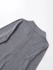 Detailed view of the heather gray knit sweater collar and fine shoulder texture