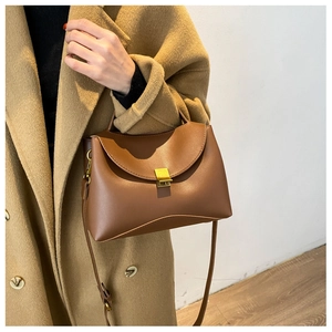 Detailed shot of brown PU leather handbag featuring a stylish gold square clasp closure