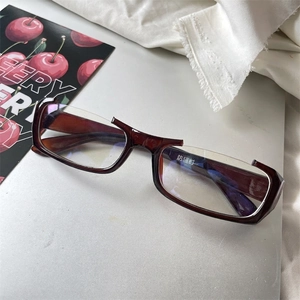 Detail of dark brown semi-rimless rectangular glasses with anti-radiation lens sticker