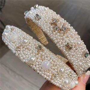 Wide headband with elegant white faux pearls and rhinestone star accents in luxury style