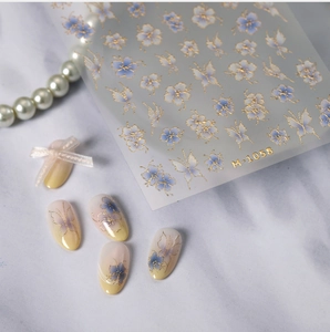 Detail of M-1058 floral nail stickers with gold embossing and blue butterfly designs