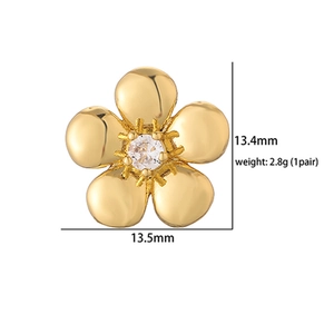 Macro shot of gold floral stud earrings with cubic zirconia, showing size and weight details