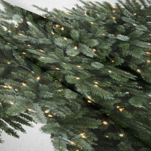 Detail of Christmas tapestry fabric showing woven texture and festive pine needle print