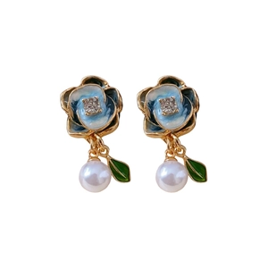 Blue enamel flower earrings with gold leaves, pearls and crystals on white background