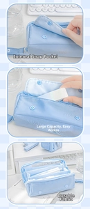 Detailed view of the light blue pencil case showing button pocket and multi-layer interior