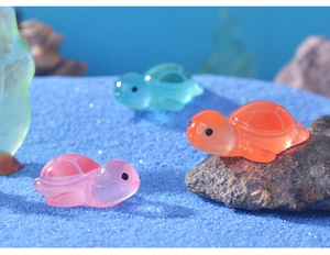 Detailed macro view of colorful resin mini turtles in a vibrant fish tank landscape