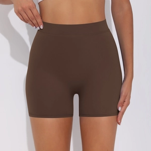 Macro detail of high-waist yoga shorts in brown showing the seamless elastic fabric texture